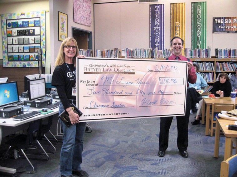 Lynn Price accepting check from Mark Breyer.